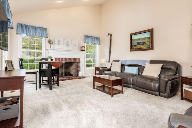 carpeted living area featuring a brick fireplace and high vaulted ceiling