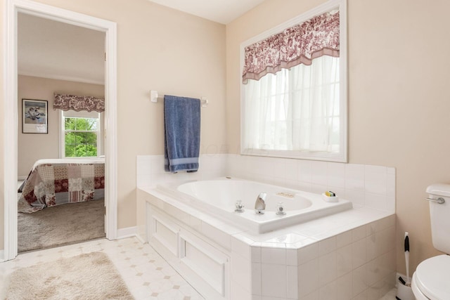 ensuite bathroom with a garden tub, toilet, and ensuite bath