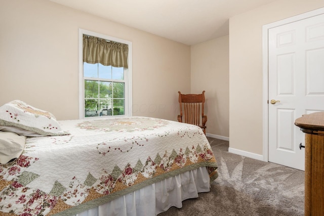 bedroom with baseboards and carpet flooring