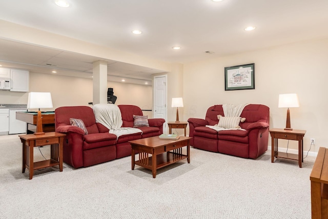 living area with light colored carpet and recessed lighting