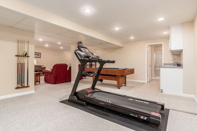 workout room with baseboards, recessed lighting, and light carpet