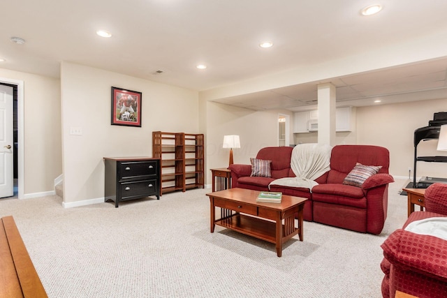 carpeted living area featuring recessed lighting, baseboards, and visible vents
