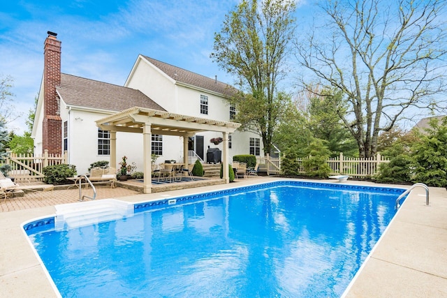 view of pool featuring a pergola, fence, a wooden deck, and a fenced in pool