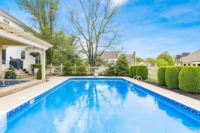 view of swimming pool featuring a fenced in pool, a fenced backyard, a patio area, and a pergola