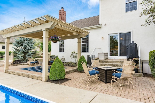 view of patio / terrace featuring an outdoor fire pit, an outdoor pool, and a pergola