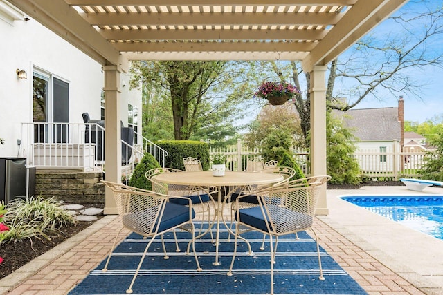view of patio / terrace with fence, a pergola, outdoor dining space, and an outdoor pool