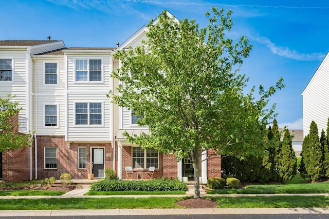 view of property featuring brick siding