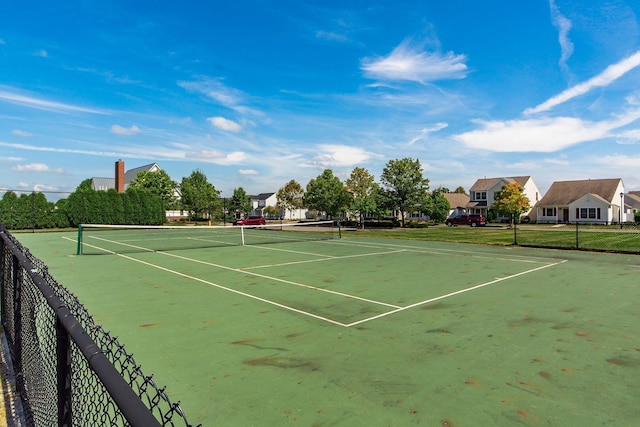 view of tennis court featuring fence