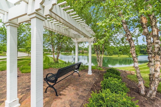 view of home's community with a water view and a pergola