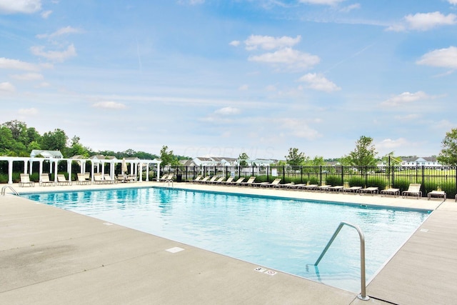 pool with fence and a patio area