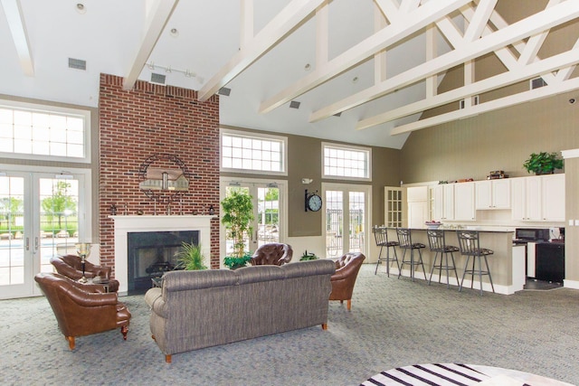 carpeted living area with high vaulted ceiling, beamed ceiling, french doors, and visible vents