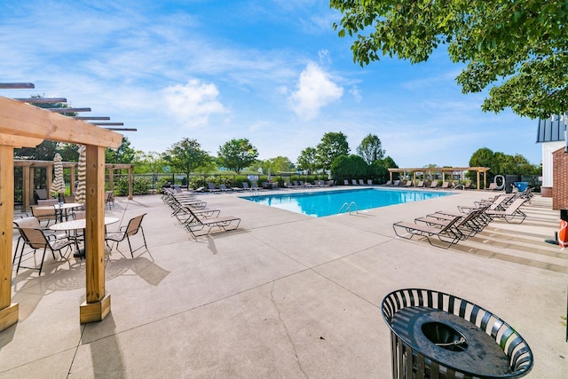pool featuring a pergola, fence, and a patio