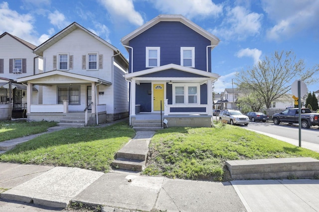view of front of house featuring a front lawn and covered porch