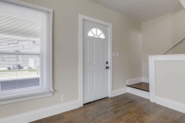 entryway with baseboards and dark wood-style floors