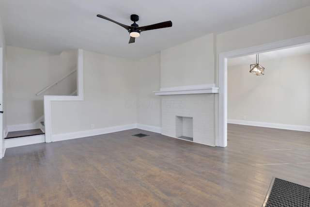 unfurnished living room with visible vents, stairs, wood finished floors, baseboards, and ceiling fan
