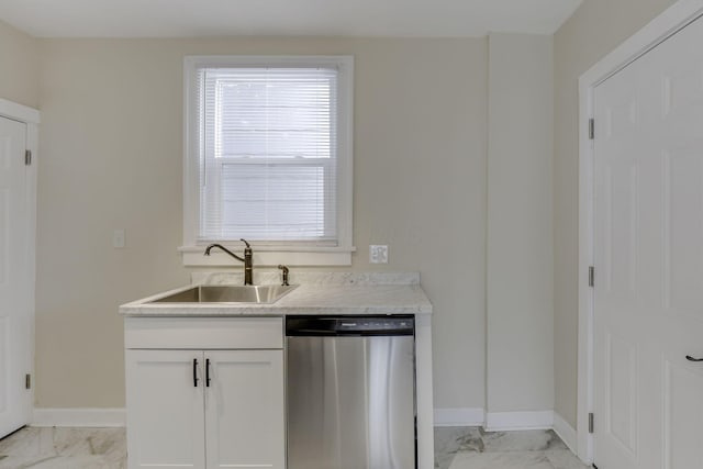 kitchen with a sink, baseboards, stainless steel dishwasher, and marble finish floor