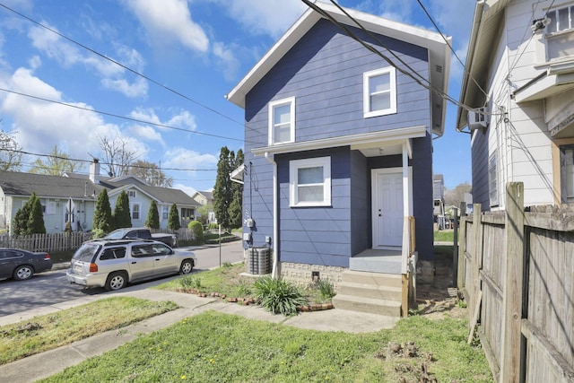 shotgun-style home with fence, central AC unit, a residential view, and crawl space