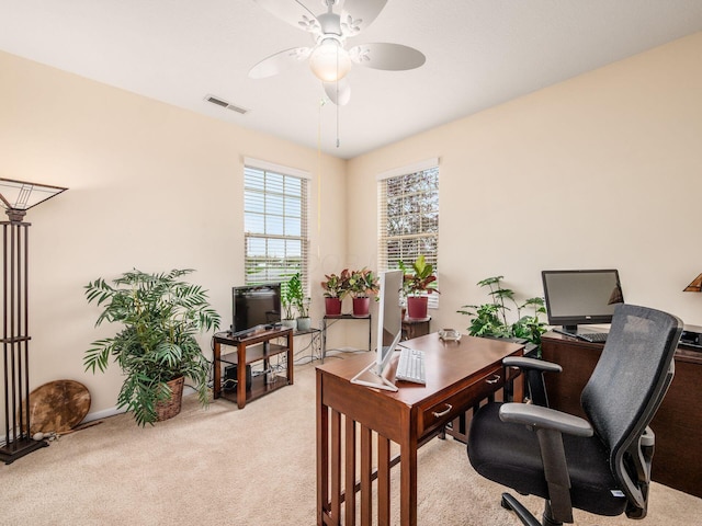 office with baseboards, light carpet, a ceiling fan, and visible vents