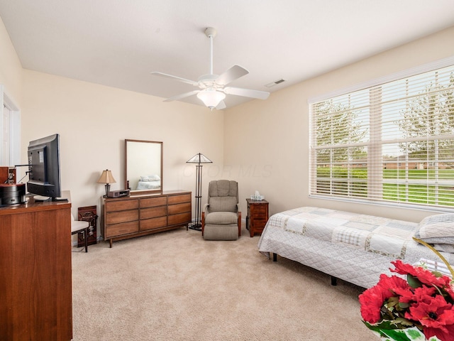 carpeted bedroom with visible vents and ceiling fan