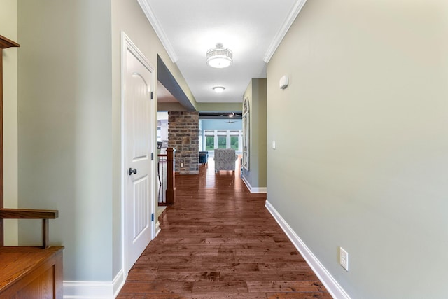 hallway with baseboards, dark wood-style floors, and ornamental molding