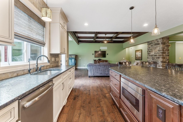 kitchen featuring dark wood-style flooring, open floor plan, a sink, coffered ceiling, and appliances with stainless steel finishes