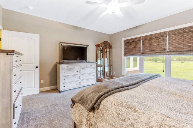 carpeted bedroom featuring baseboards and a ceiling fan