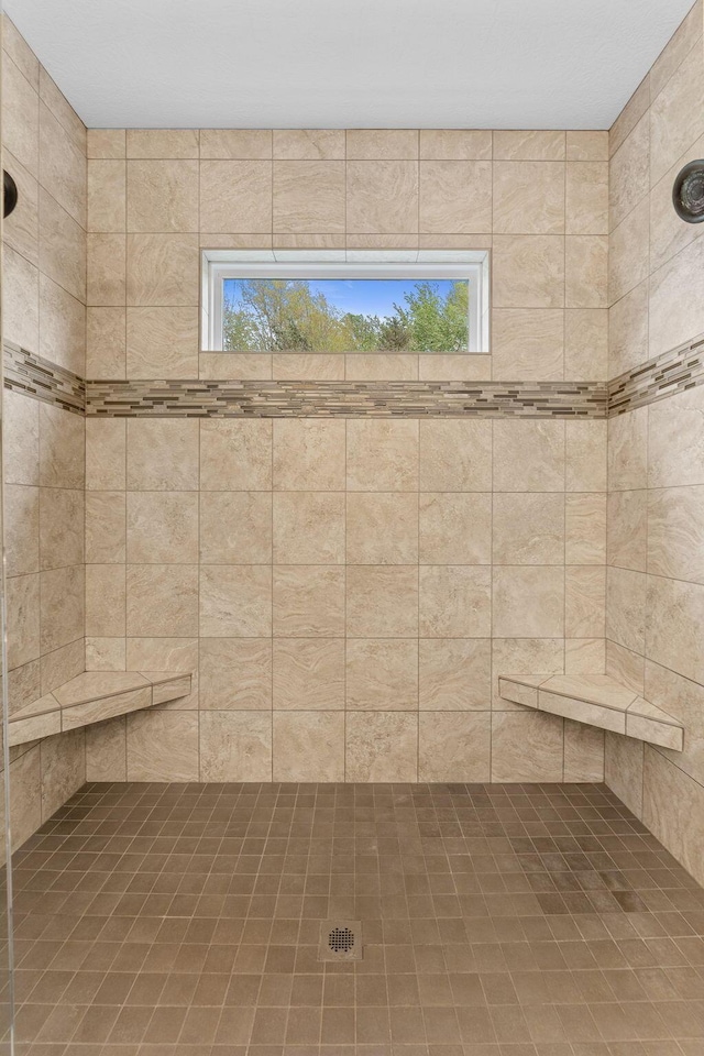 full bath with a tile shower