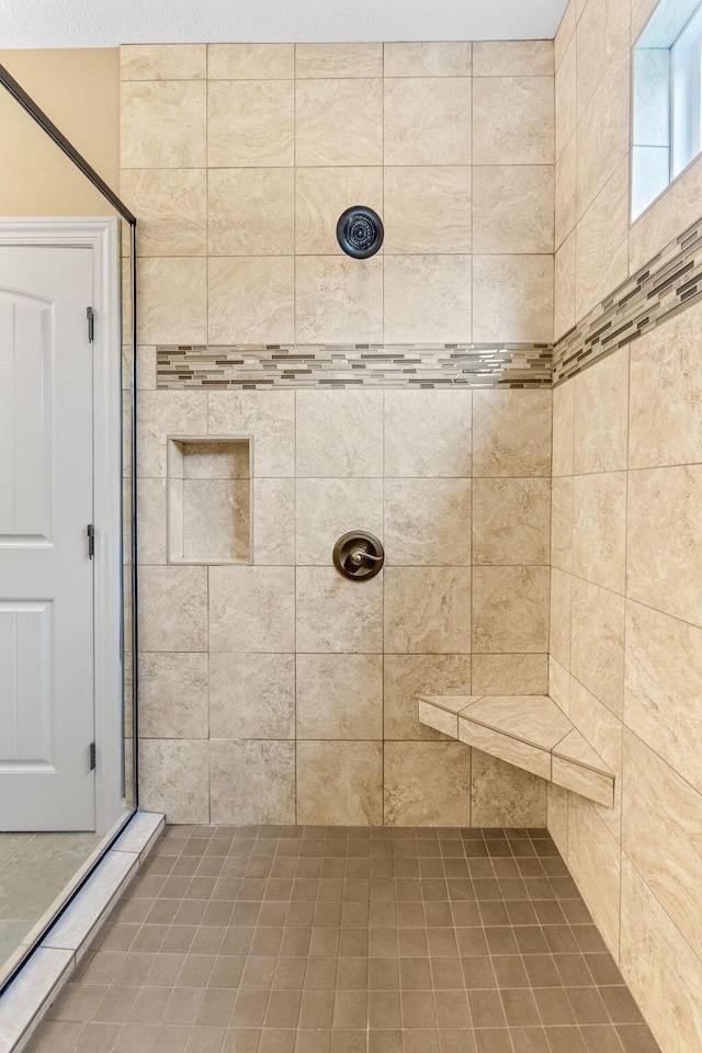 bathroom with a tile shower