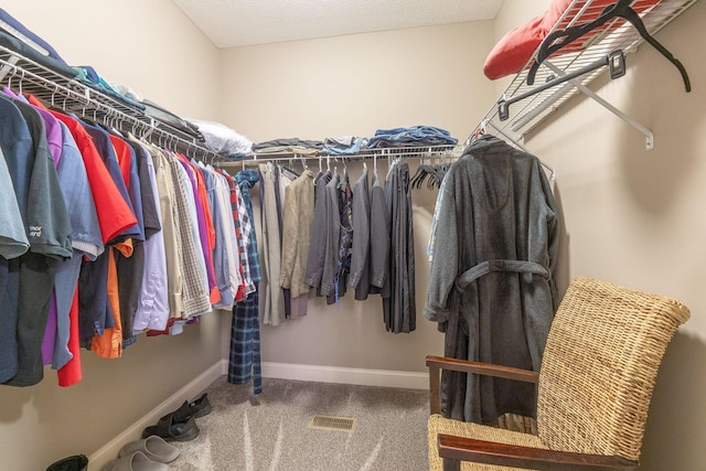 walk in closet with visible vents and carpet flooring