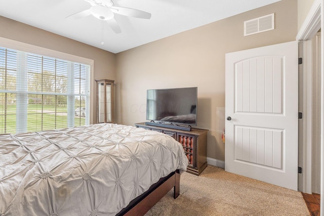 bedroom featuring visible vents, a ceiling fan, and carpet floors