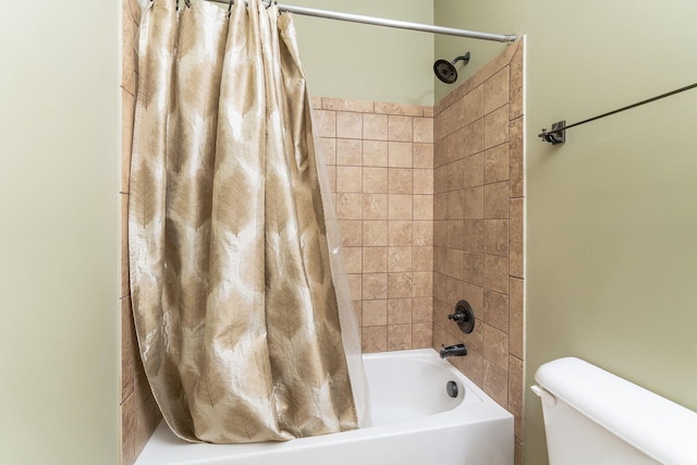 bathroom with shower / bath combo with shower curtain and toilet