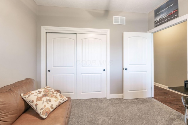 sitting room featuring baseboards, carpet, and visible vents