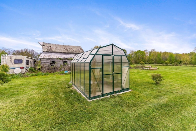 view of greenhouse featuring a lawn