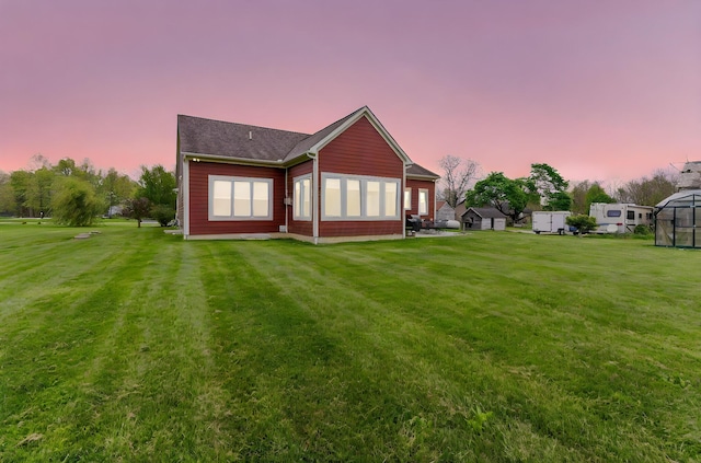 rear view of house featuring a lawn