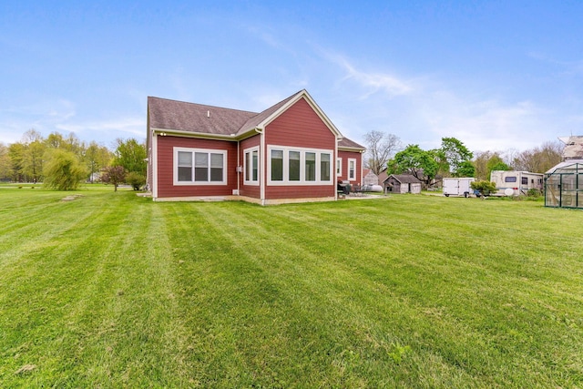 back of house with a lawn