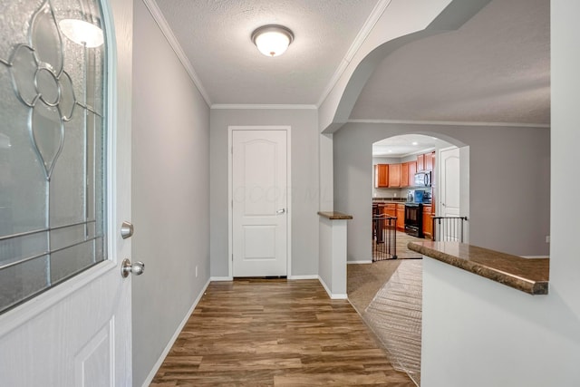 24796 E Fork Rd, Laurelville, OH 43135 - entryway featuring crown molding, arched walkways, a textured ceiling, and wood finished floors