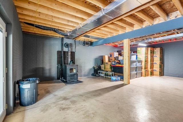 24796 E Fork Rd, Laurelville, OH 43135 - unfinished basement with a wood stove and brick wall