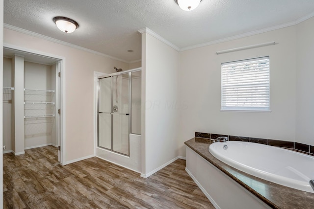 24796 E Fork Rd, Laurelville, OH 43135 - bathroom with crown molding, wood finished floors, a spacious closet, a bath, and a stall shower