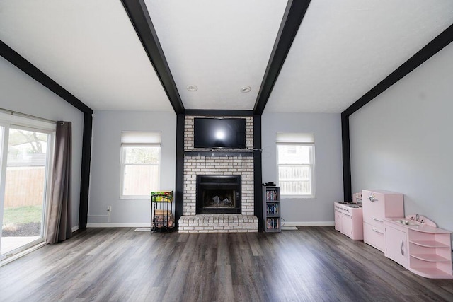living room with baseboards, a brick fireplace, wood finished floors, and beamed ceiling