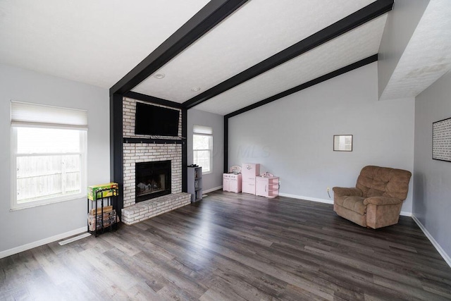 unfurnished living room featuring a brick fireplace, dark wood-style flooring, baseboards, and vaulted ceiling with beams