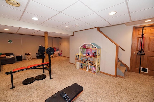 exercise area featuring recessed lighting, baseboards, a paneled ceiling, and carpet