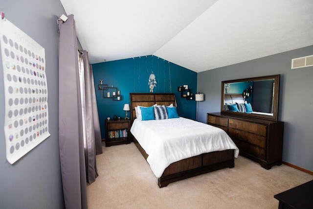 carpeted bedroom featuring baseboards, visible vents, and lofted ceiling