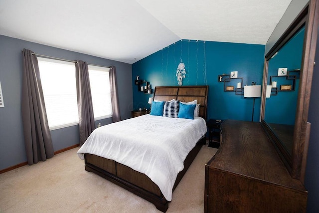 carpeted bedroom with baseboards and lofted ceiling