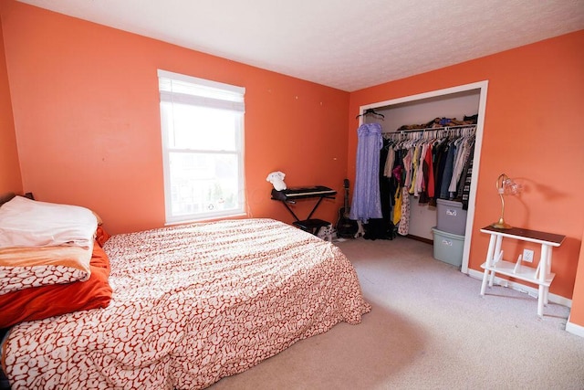 bedroom featuring baseboards, a closet, and carpet flooring