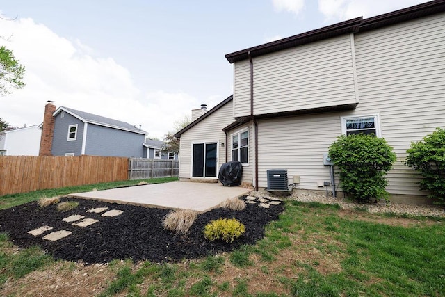 rear view of house with central AC, a patio area, and fence