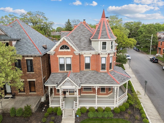 884 Neil Ave, Columbus, OH 43215 - victorian house with covered porch, brick siding, and a high end roof