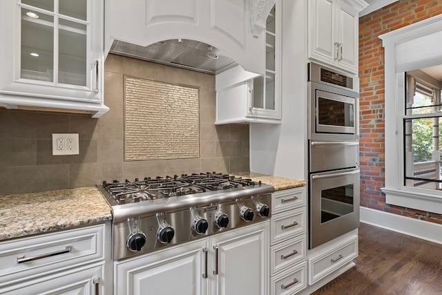 884 Neil Ave, Columbus, OH 43215 - kitchen featuring appliances with stainless steel finishes, white cabinets, glass insert cabinets, dark wood-type flooring, and tasteful backsplash