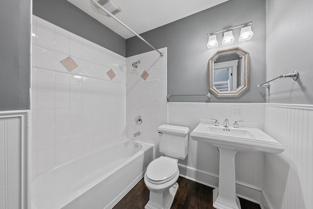 884 Neil Ave, Columbus, OH 43215 - bathroom featuring shower / bath combination, wainscoting, and wood finished floors