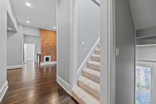 884 Neil Ave, Columbus, OH 43215 - staircase featuring wood finished floors, recessed lighting, built in shelves, and a brick fireplace