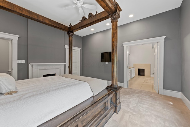884 Neil Ave, Columbus, OH 43215 - bedroom with a fireplace, light colored carpet, recessed lighting, connected bathroom, and light tile patterned floors